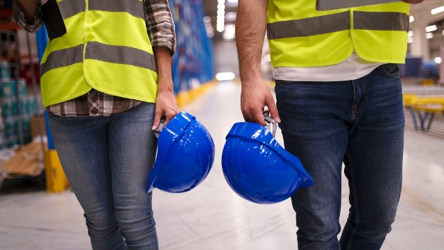 two-unrecognizable-workers-reflective-suit-walking